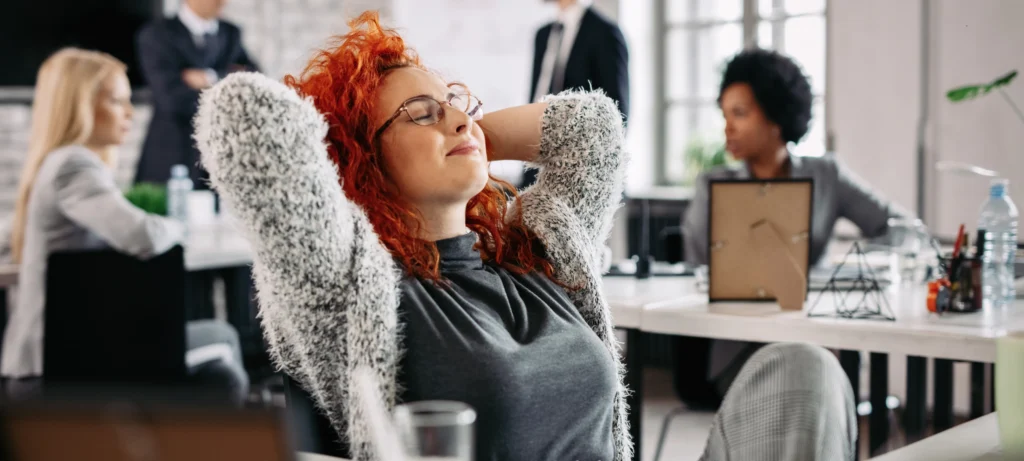 Relaxed employee amid workplace chaos